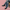 Black LV sneakers with white laces worn with blue jeans against a pink background